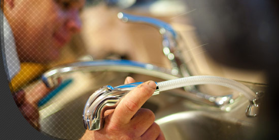 A Lynchburg, VA. plumber working on a sink